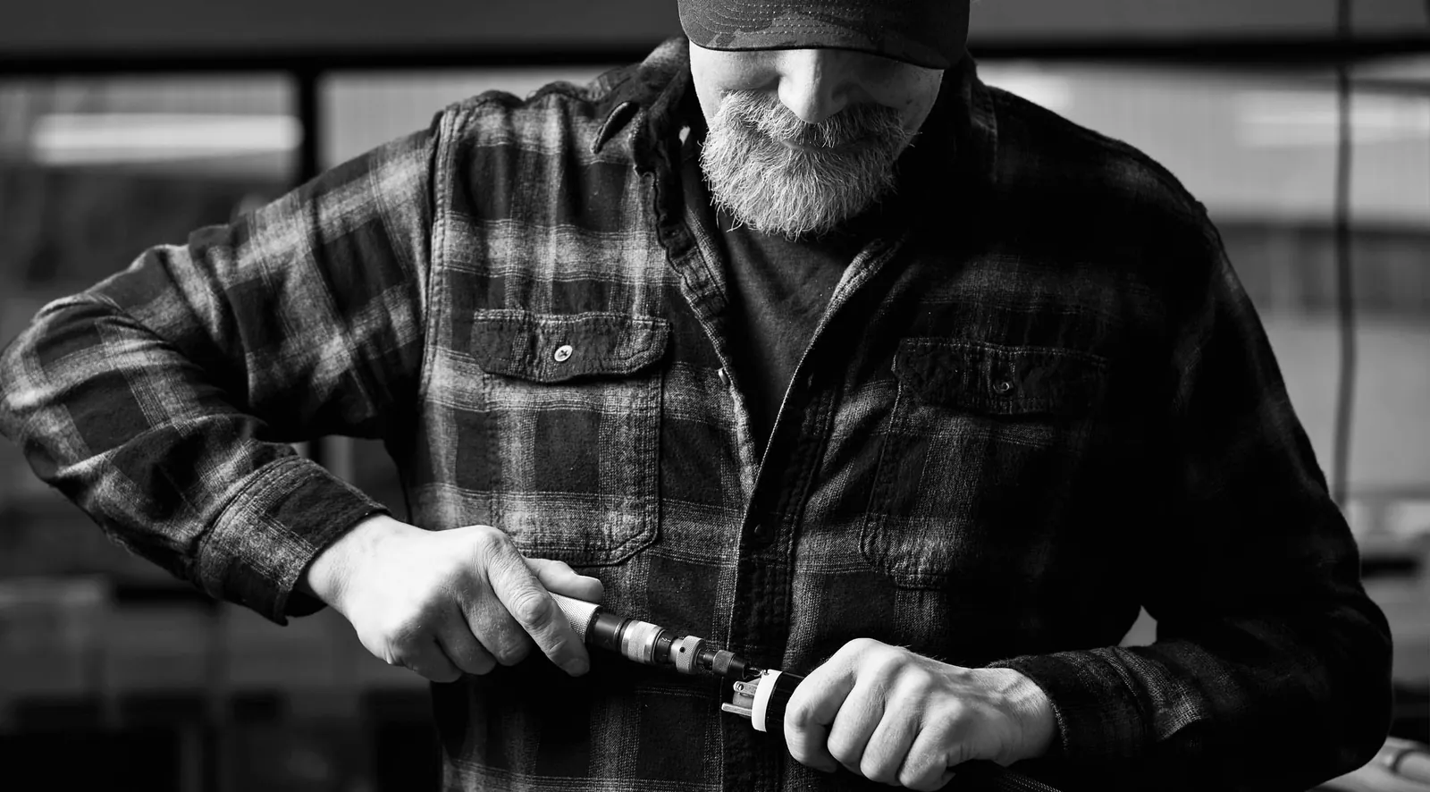 A technician torquing a connector by hand at the Shunyata bench.